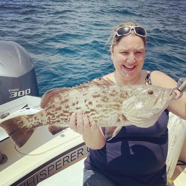 Happy Woman Holding A Fish