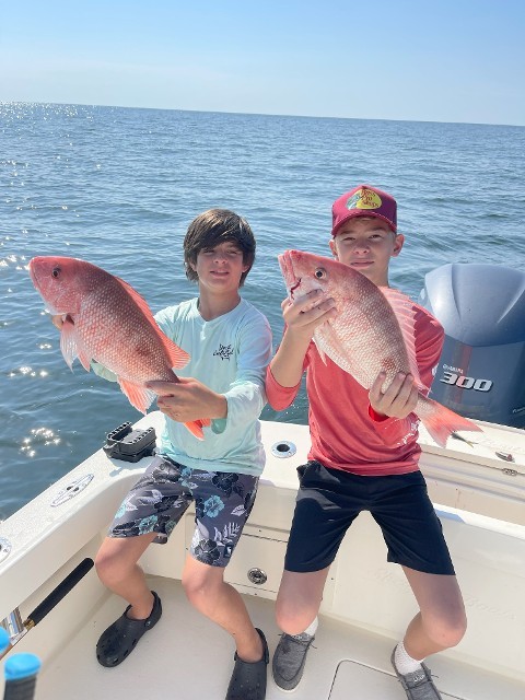 Two Young Boys With Fishes