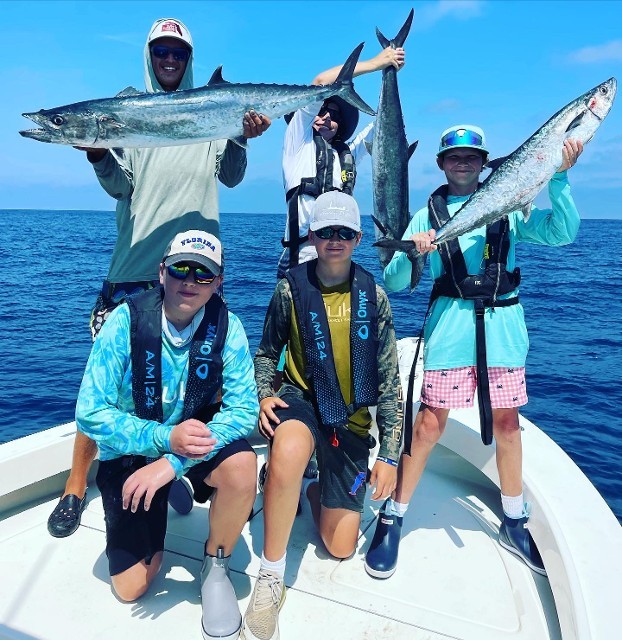 Five Member Crew Showing Holding Fish