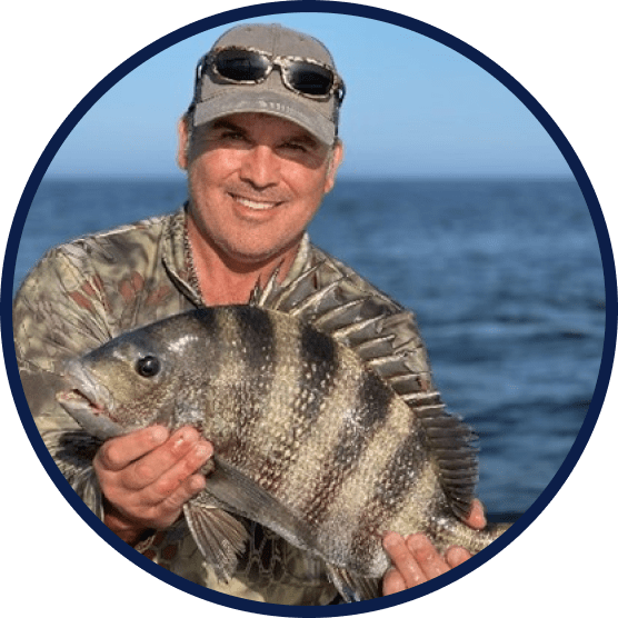 Man In The Middle Of The Ocean Holding A Fish