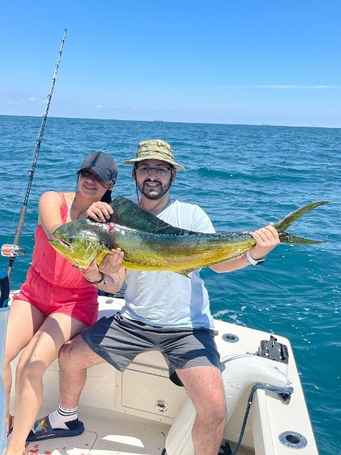 Couple Holding A Big Green Fish