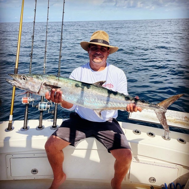 Man Sitting Holding A Fish