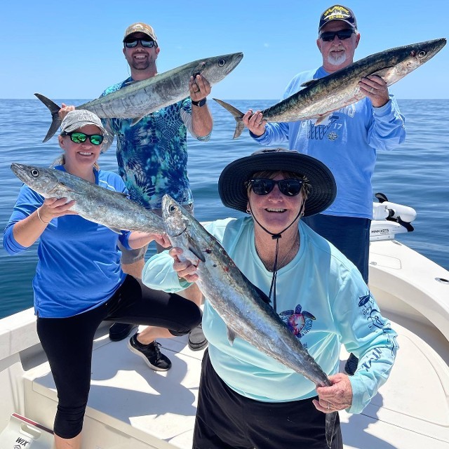 Group Of Individual Holding A Fish