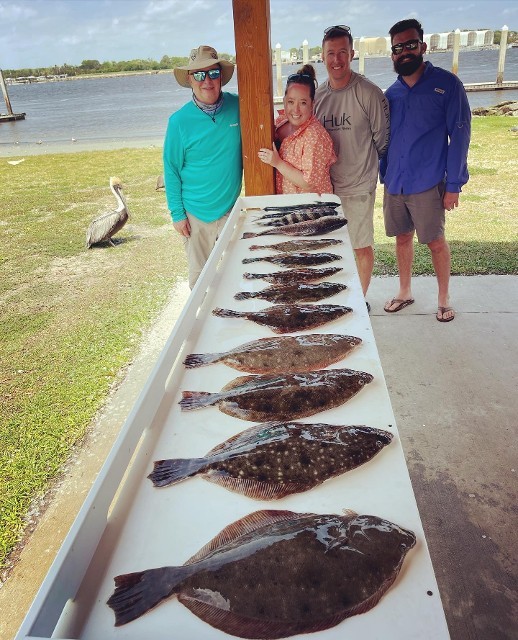 Group Of Individual Showing The Fishes They Caught