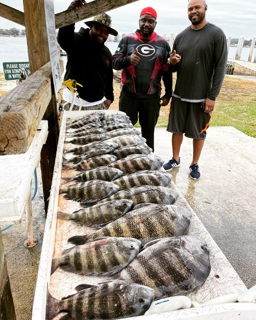 Three Men With The Fishes They Caught