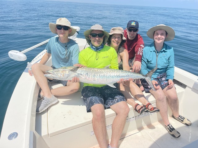 Happy Family Holding A Big Silver Fish