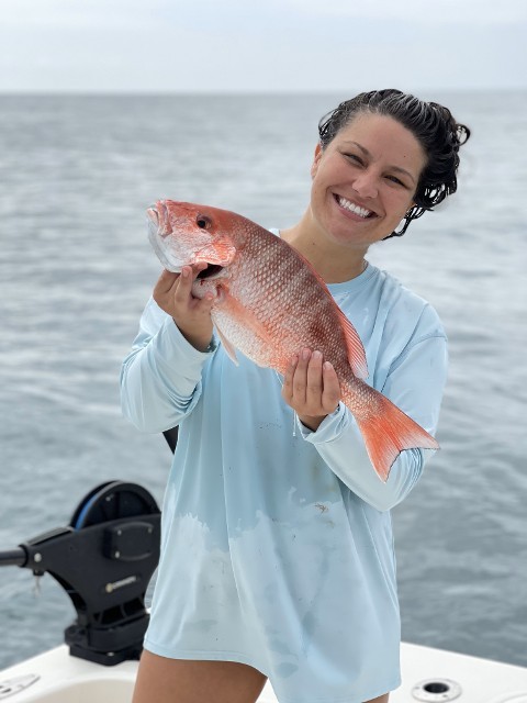 Woman Holding A Big Orange Fish