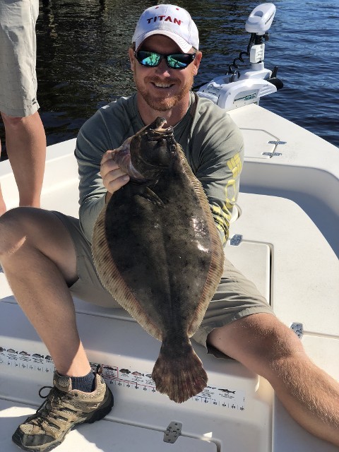 Man Holding A Large Green Fish