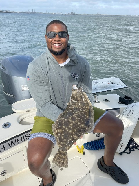 Man Happily Holding The Fish That He Caught