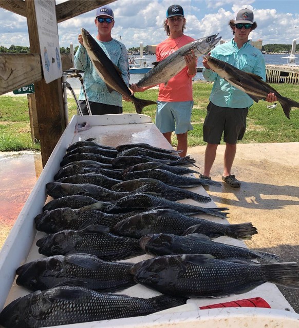 Three Young Men With The Fishes That They Caught