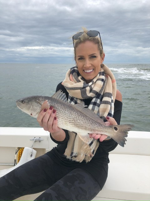 Woman Wearing A Scarf Holding A Fish