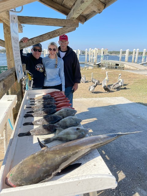 Smiling Family Next To A Group Of Fishes