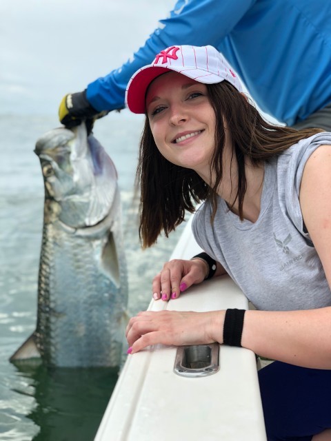 Woman With Cap Holding A Big Fish