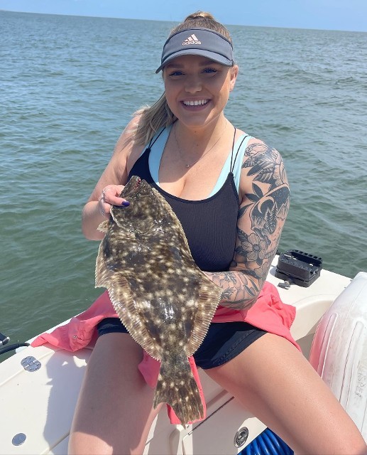 Smiling Woman With Tattoo Holding Fish