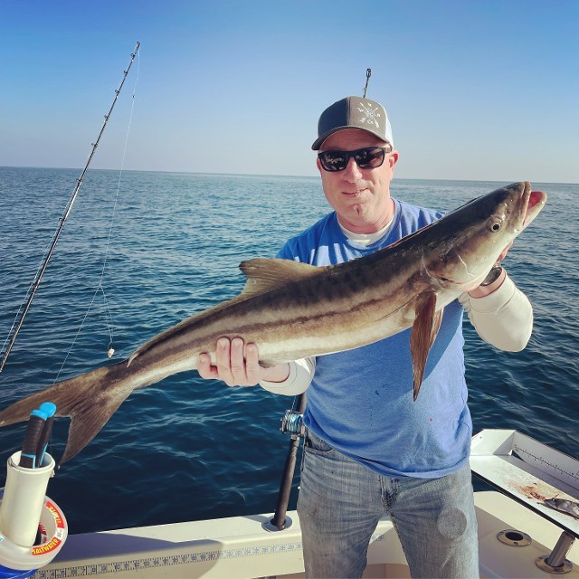 Happy Man Showing A Big Fish