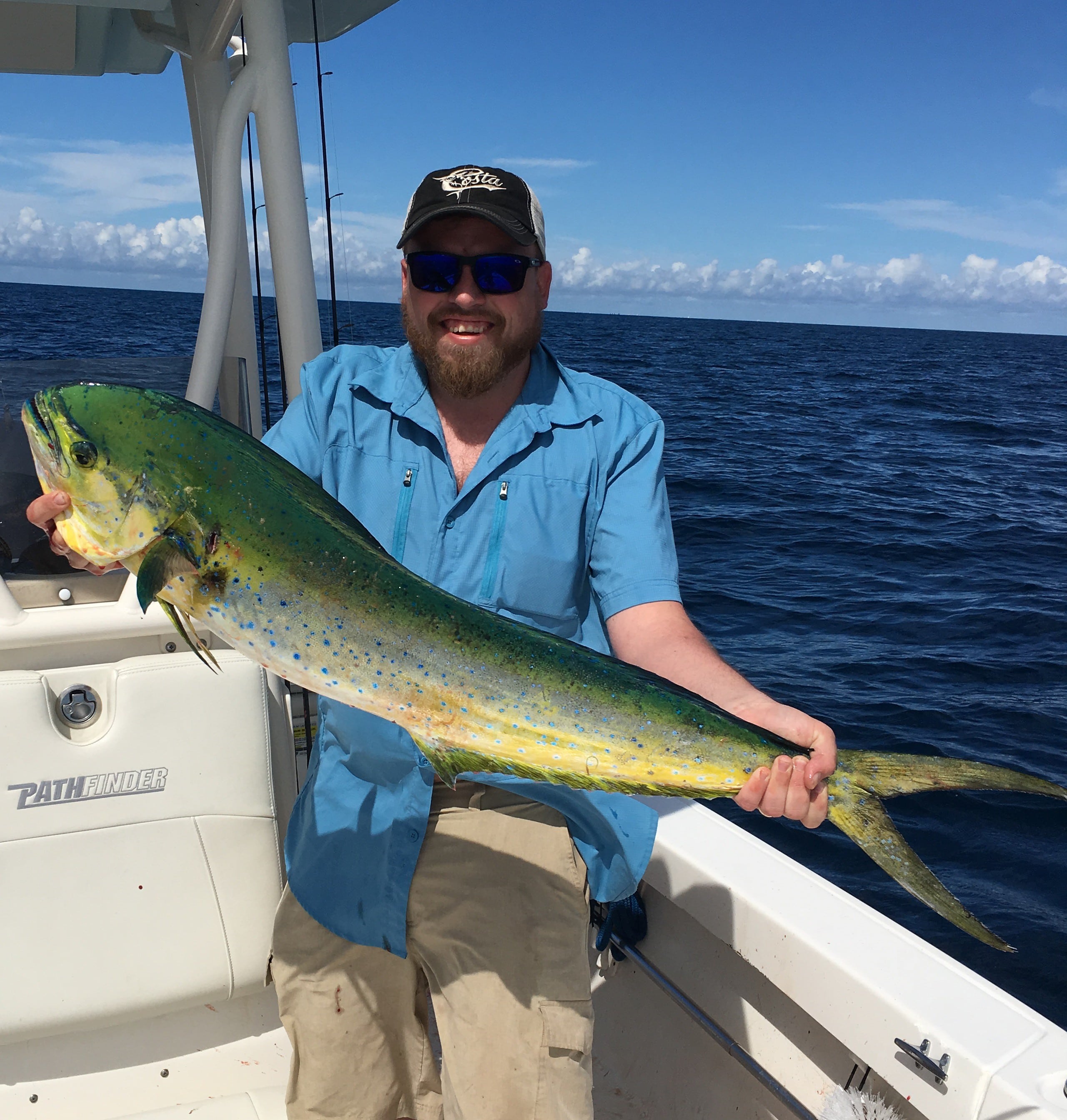 Man Holding A Green Fish