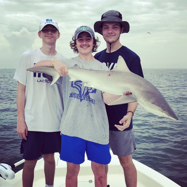 Three Young Individuals Caught A Shark