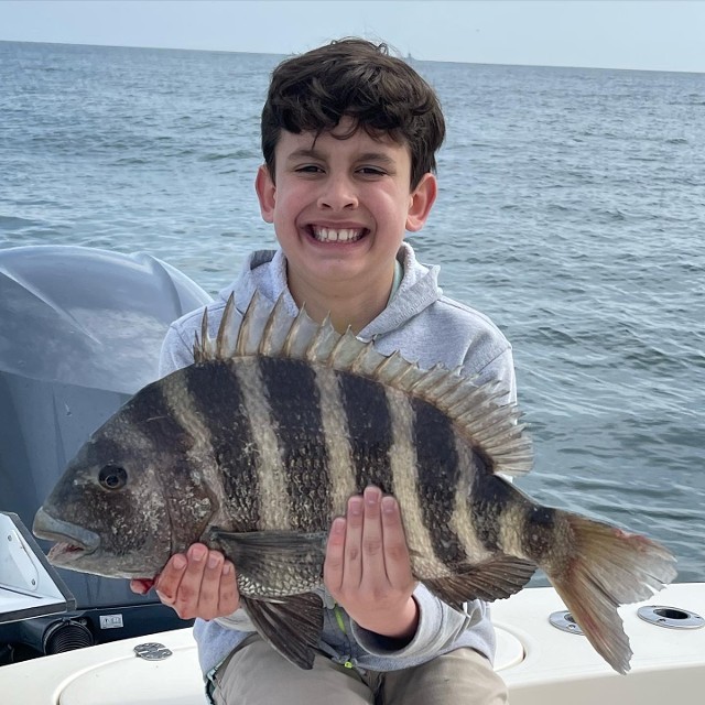 Young Boy Holding A Fish