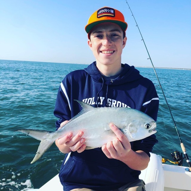 Happy Young Teenager Holding A Fish