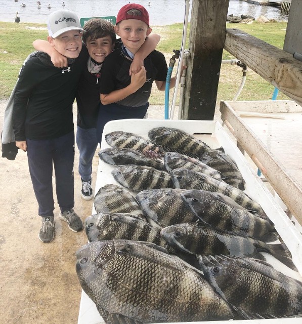 Three Young Boys With The Fishes That They Caught