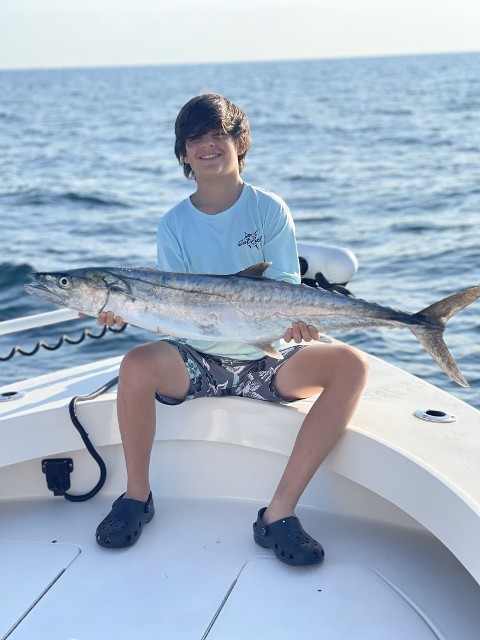 Young Boy Holding A Big Fish