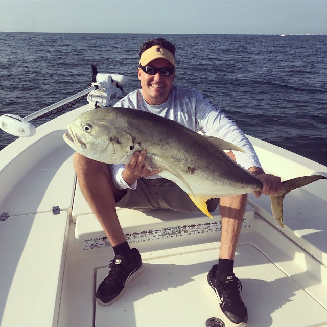 Smiling Young Man Holding The Fish He Caught