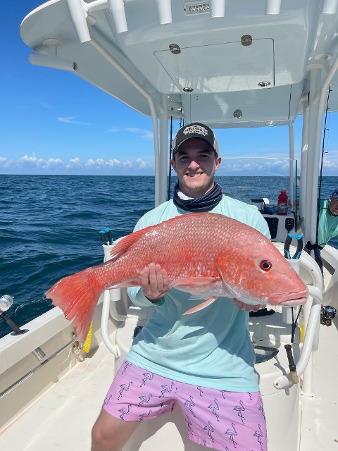 Man Holding A Big Orange Fish