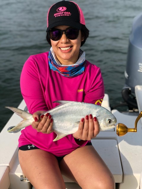 Woman In Pink Jacket Holding A Fish