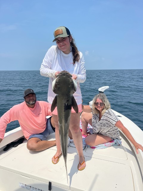 Group Image With One Woman Holding A Fish