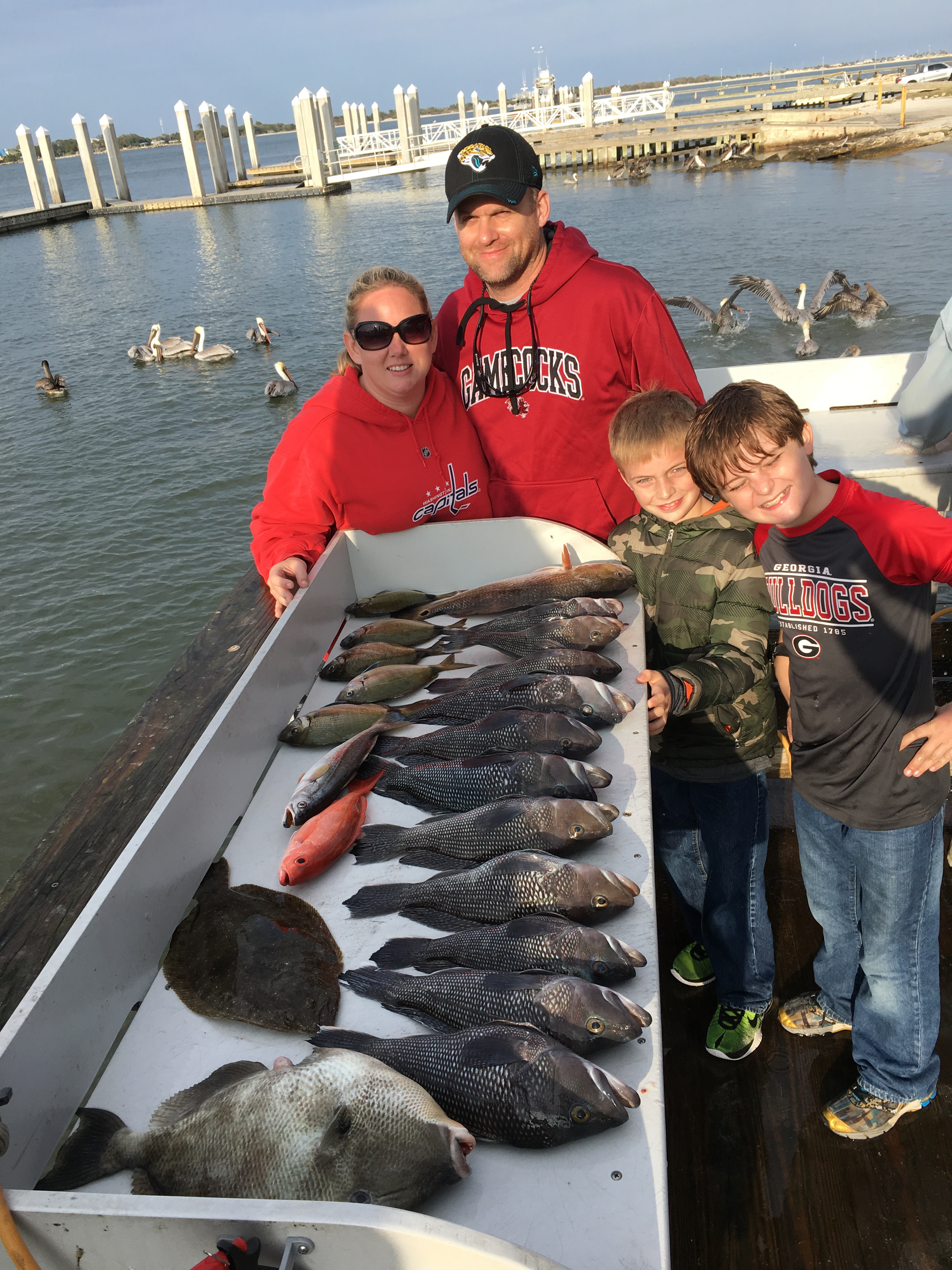 Family Standing Next To Their Catch